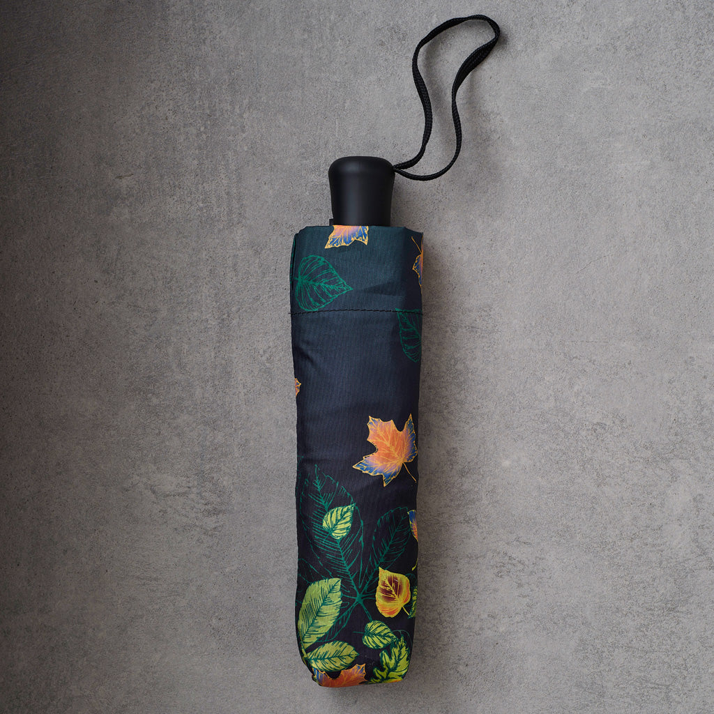dark umbrella with a colorful orange and green leaf pattern,