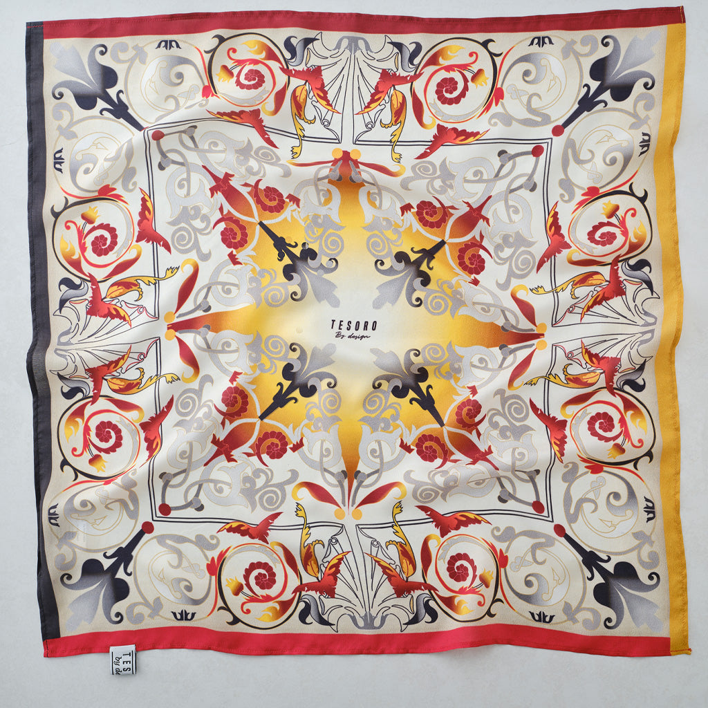 A square silk scarf featuring a symmetrical, ornate folk-art style design with red roses, yellow sunburst, and black, gray, and gold details on a cream background. The brand name 'TECCA' is printed in the center.
