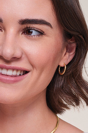 close up of model wearing Gold Plated Hinged Hooped Earrings