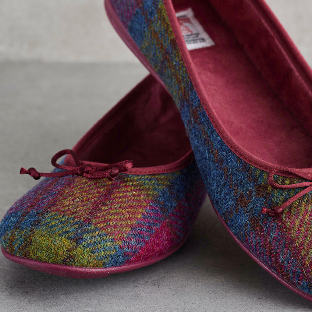 A pair of ballet flats with a multicolor tweed pattern in blue, green, yellow, and pink, featuring a solid burgundy velvet interior and matching bow details.