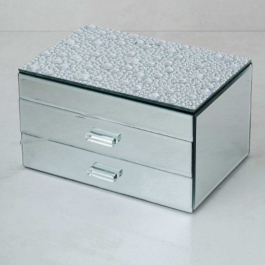 A rectangular mirrored jewelry box with two drawers and a textured, pebble-patterned top, shown on a light gray background.