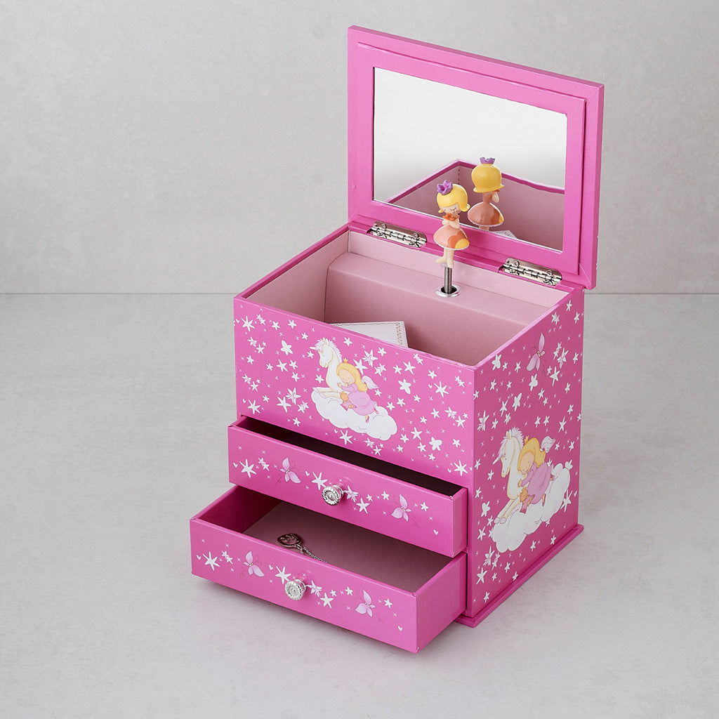 A pink children's jewelry box with a mirror on the lid, two drawers, and fairy illustrations with white stars. A small figurine stands on the inside of the lid.