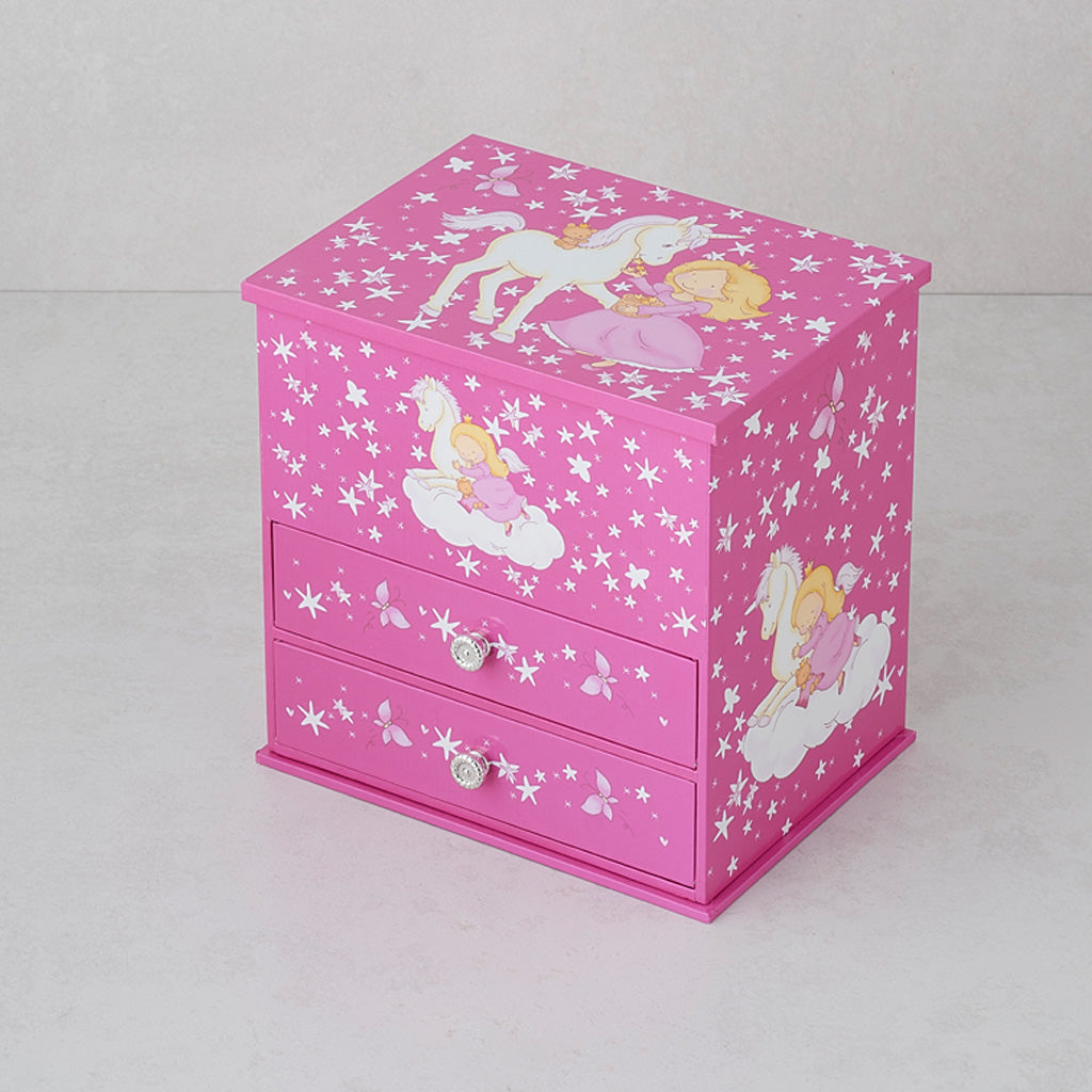 A pink wooden jewelry box with two drawers and a lid decorated with white stars, butterflies, and fairy illustrations, set against a neutral light gray background.