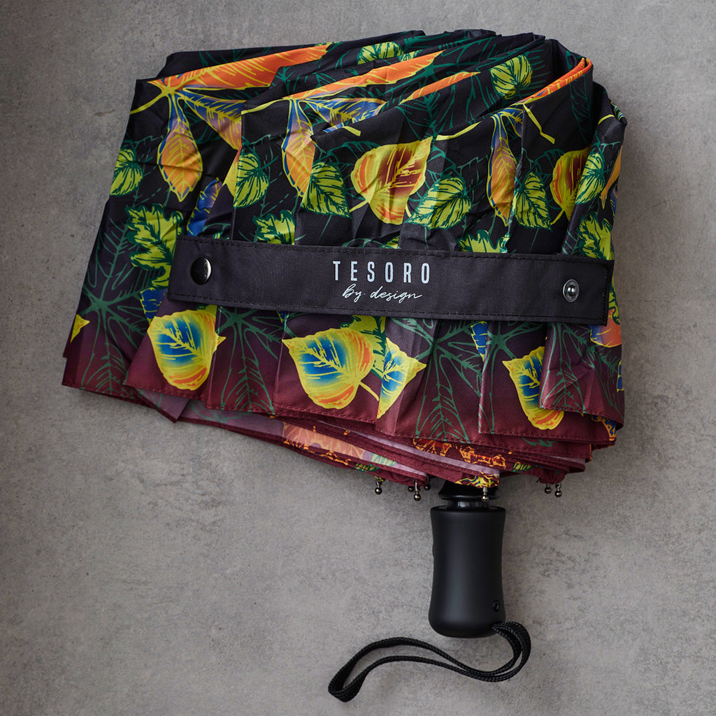  dark umbrella with a colorful orange and green leaf pattern.