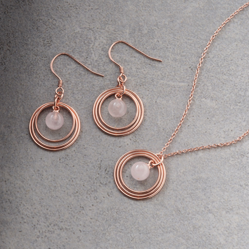 Rose Gold Plated & Rose Quartz Triple Disc Necklace and Earrings on grey back ground
