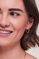 close up of model wearing Gold Plated Hinged Hooped Earrings