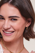 model wearing Gold Plated Hinged Hooped Earrings
