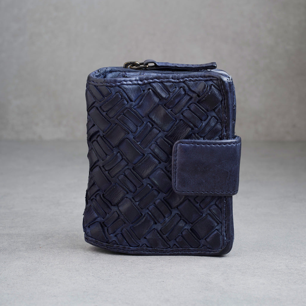 A dark navy blue woven leather wallet with a zippered top and a small matching flap closure, photographed against a neutral gray background.